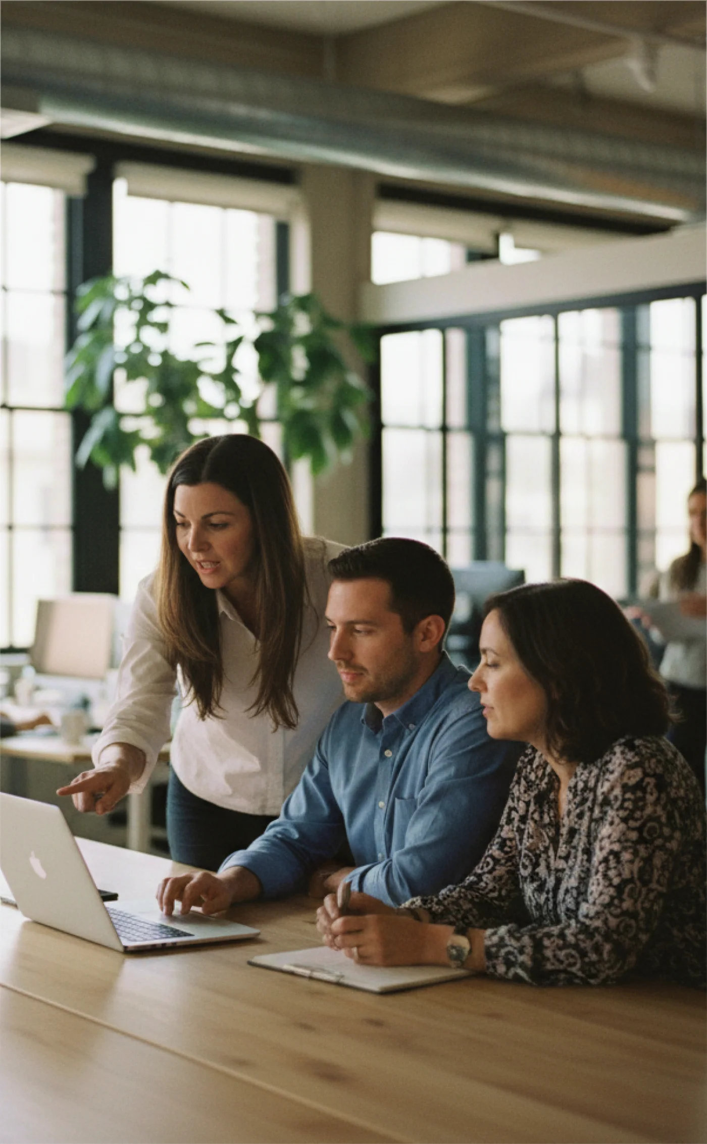 A team reviewing their payments program together at a laptop